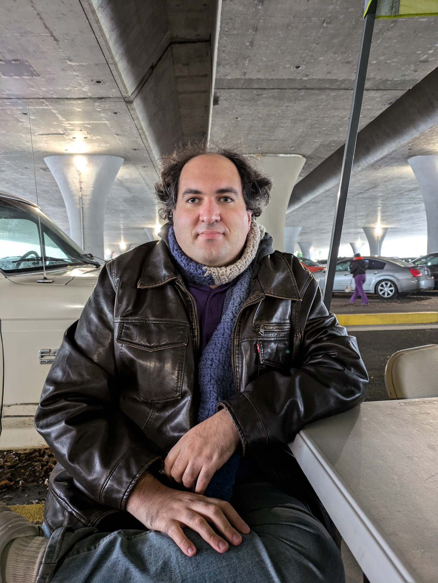 Image of Alma Wilcox standing in front of foliage.